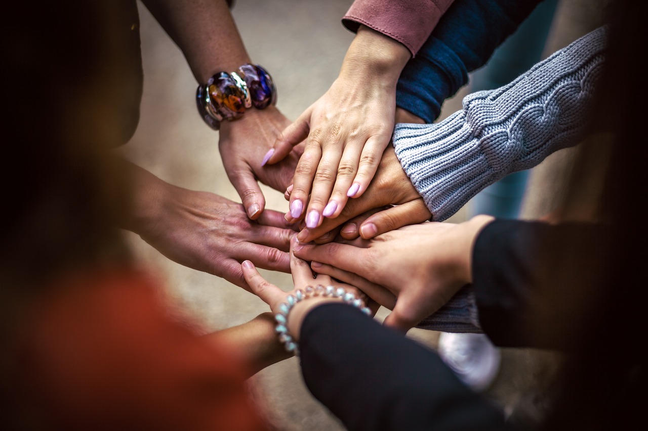 People joining hands in a circle